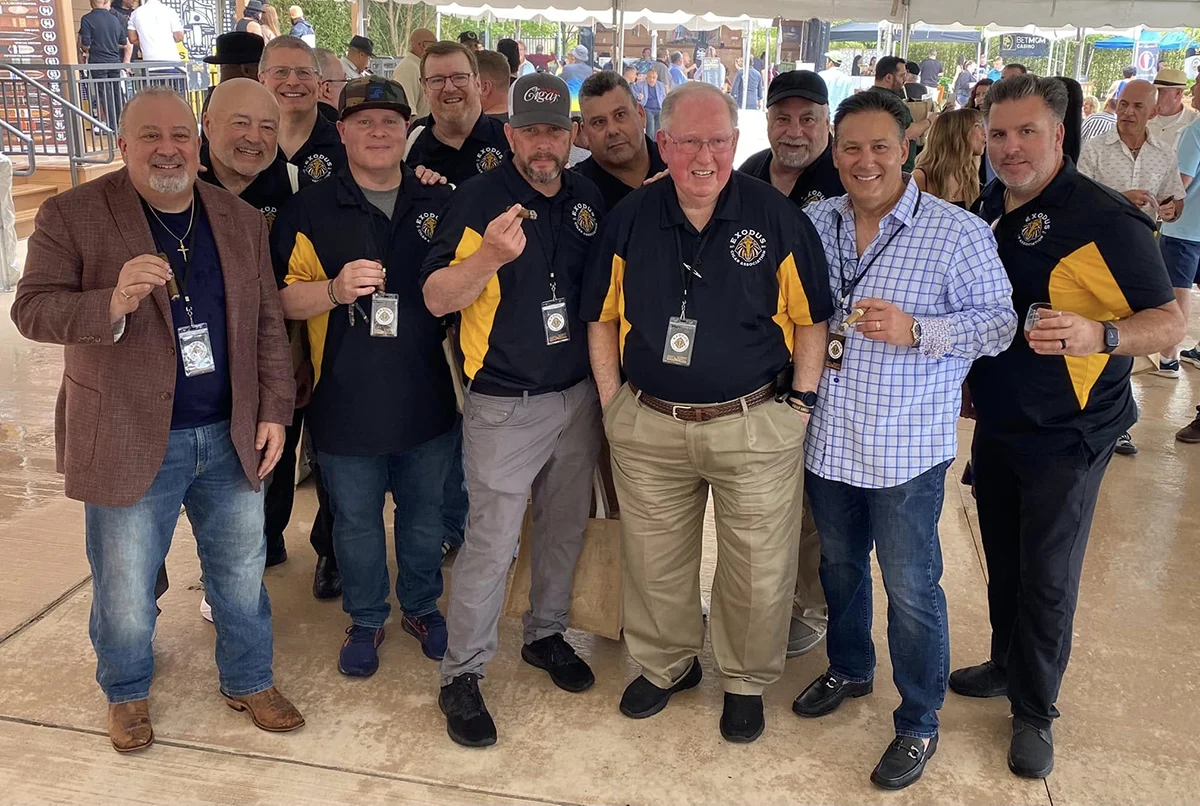 Exodus members in club shirts with cigars at a members' outing